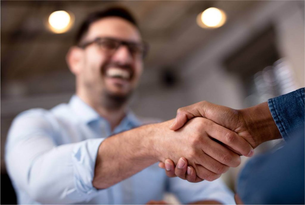 Customer and Team Member Shake Hands Post Successful Mortgage Approval