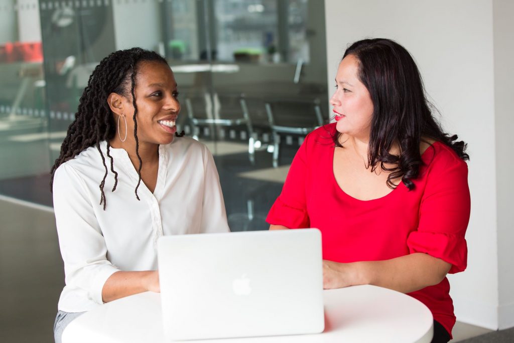 Two Women Discussing Various Borrower Services Options